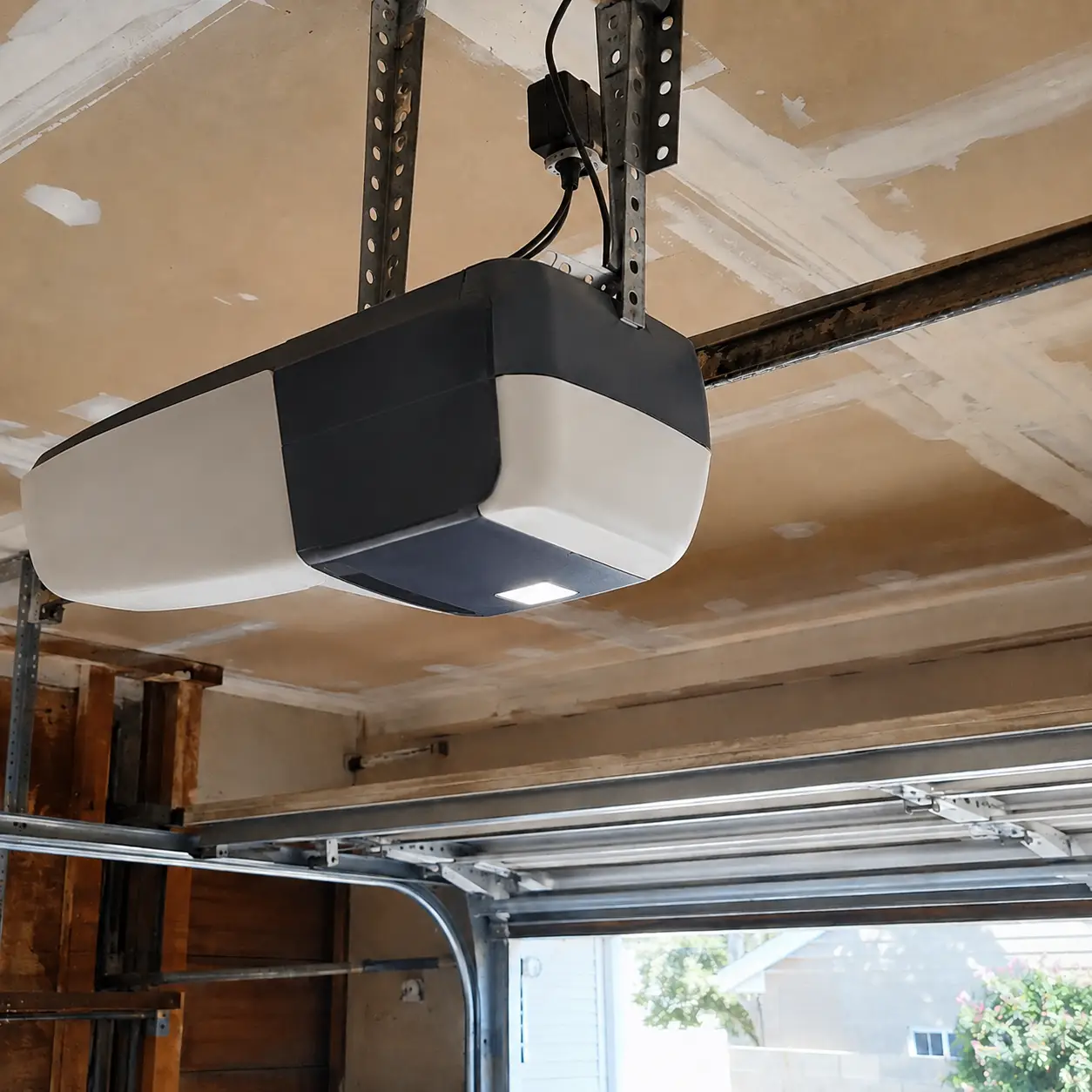 Garage door opener technician completing automatic opener service