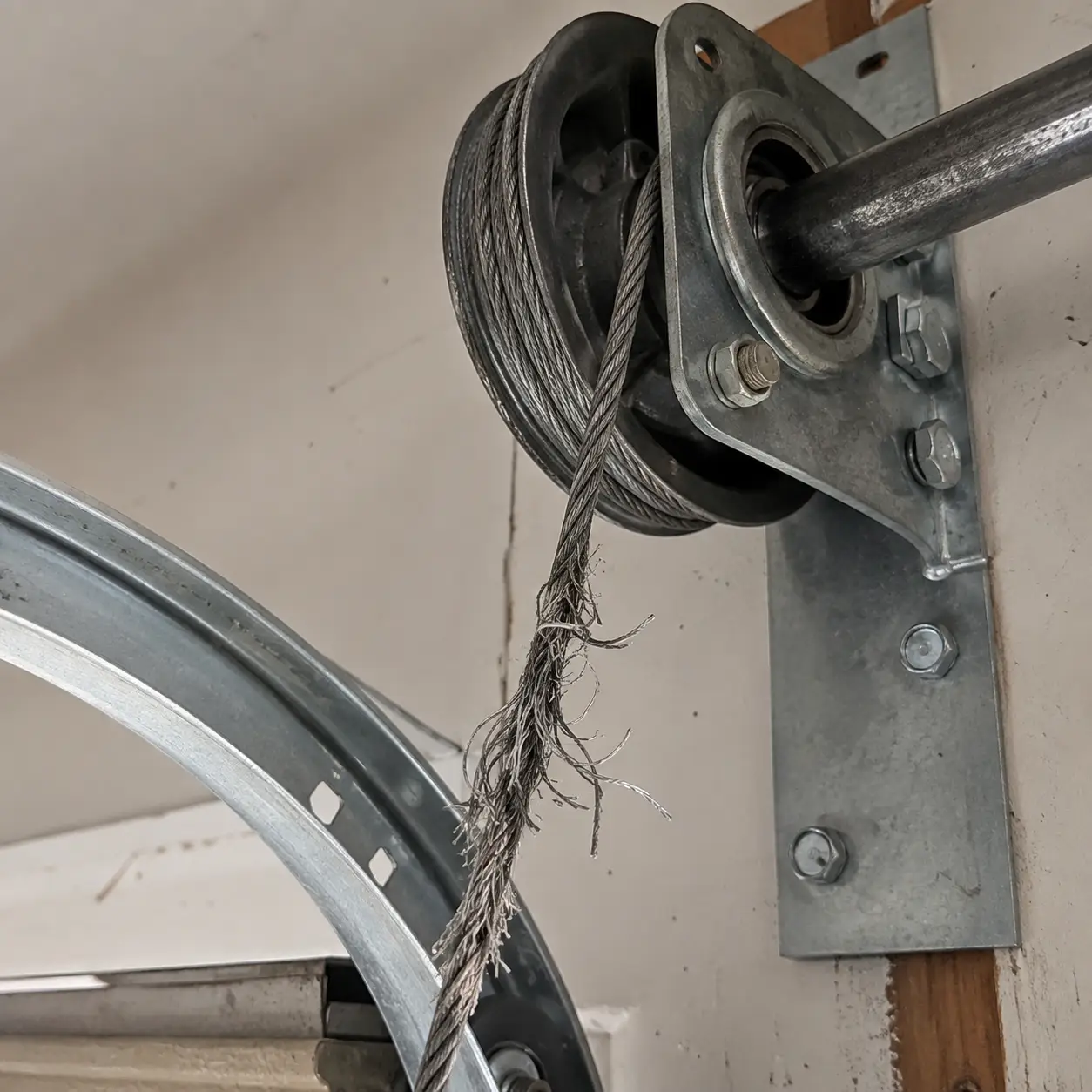Garage door parts inspection with rollers and hardware replacement